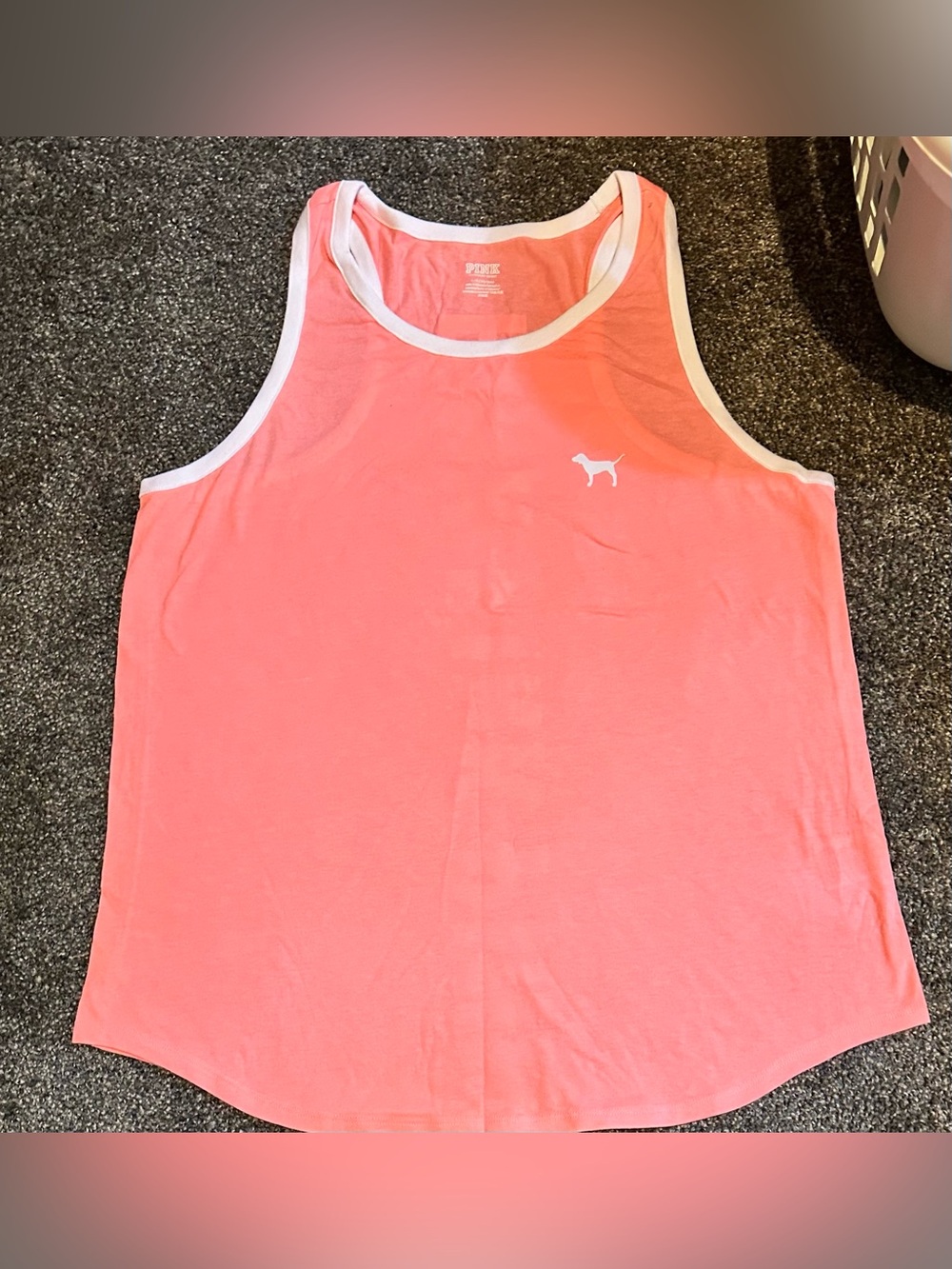 VS PINK Racerback tank top in coral with white lettering on back spelling PINK